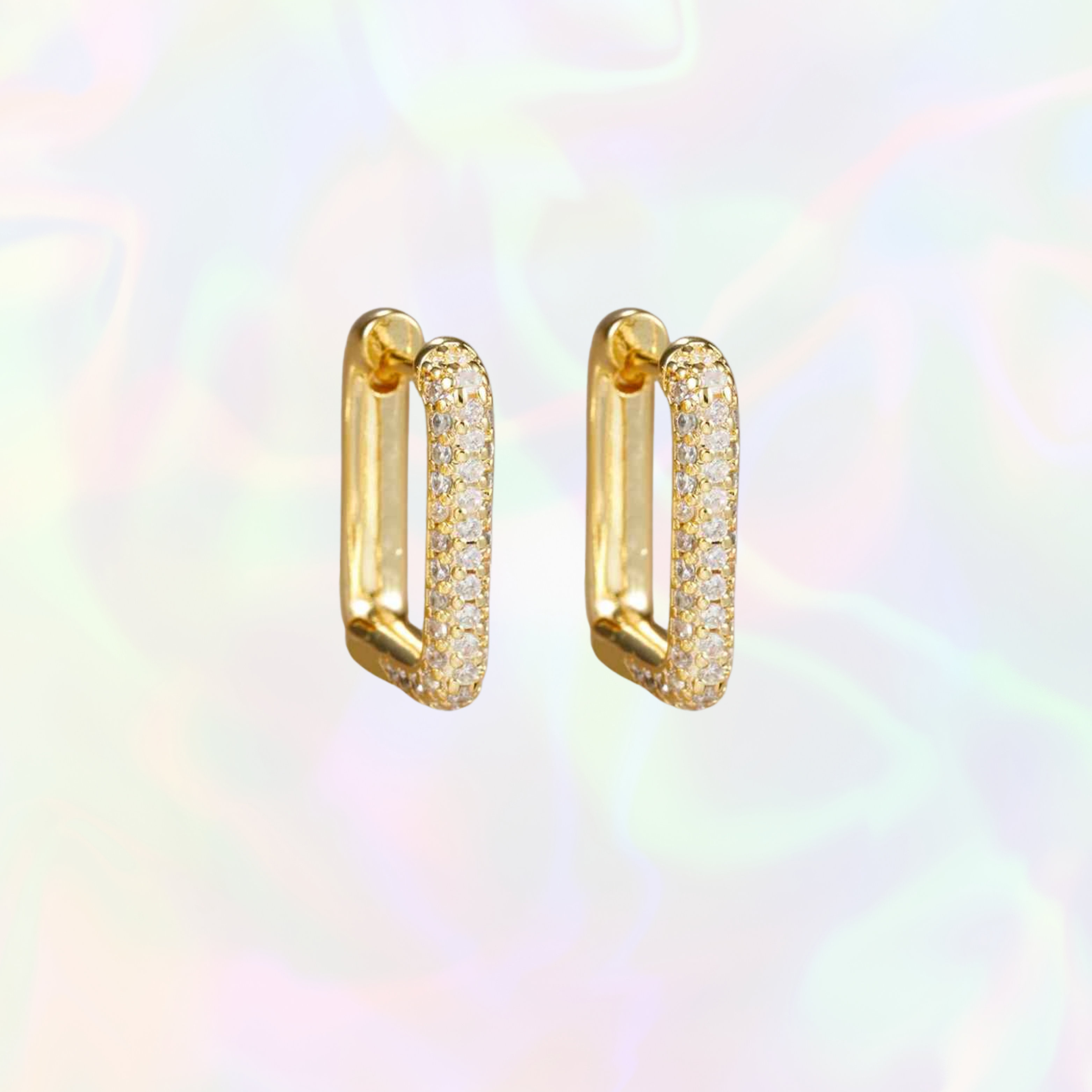 Gold square hoop earrings with embedded stones on a multicolored background