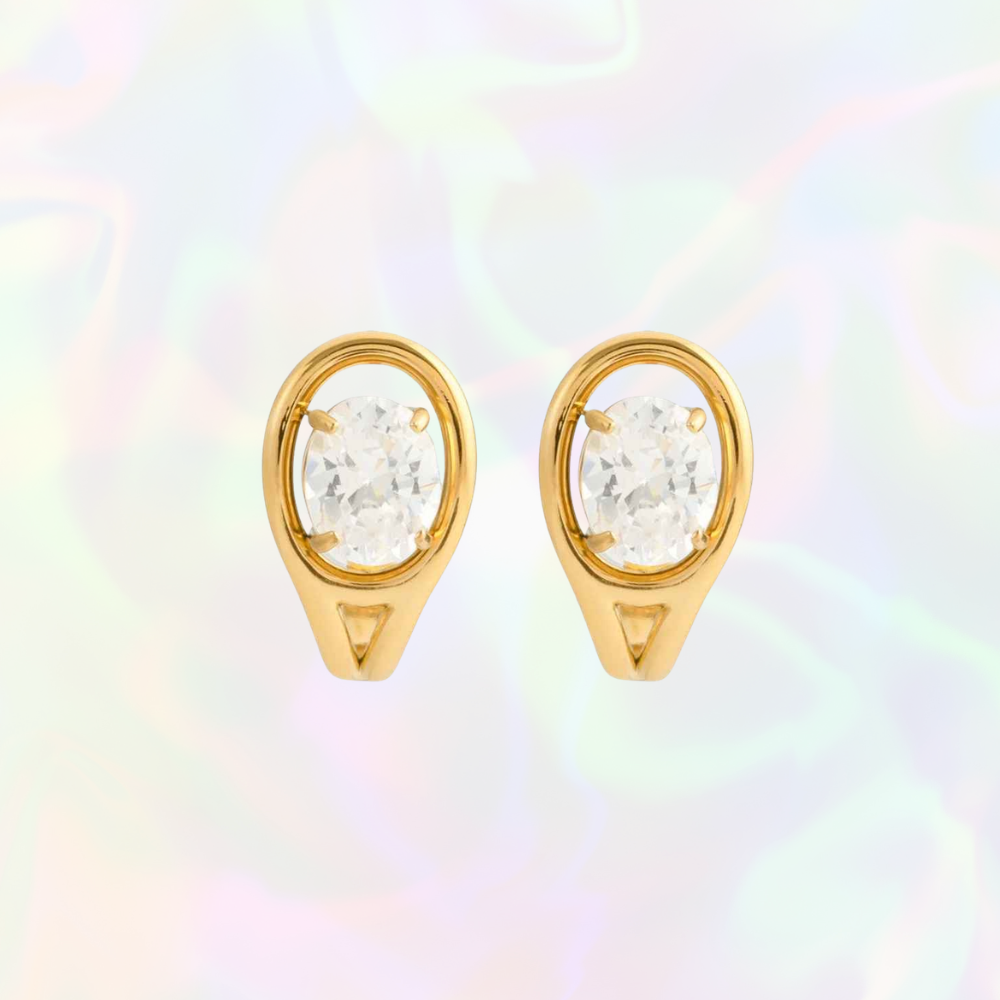 Gold earrings with clear gemstones on a multicolored background