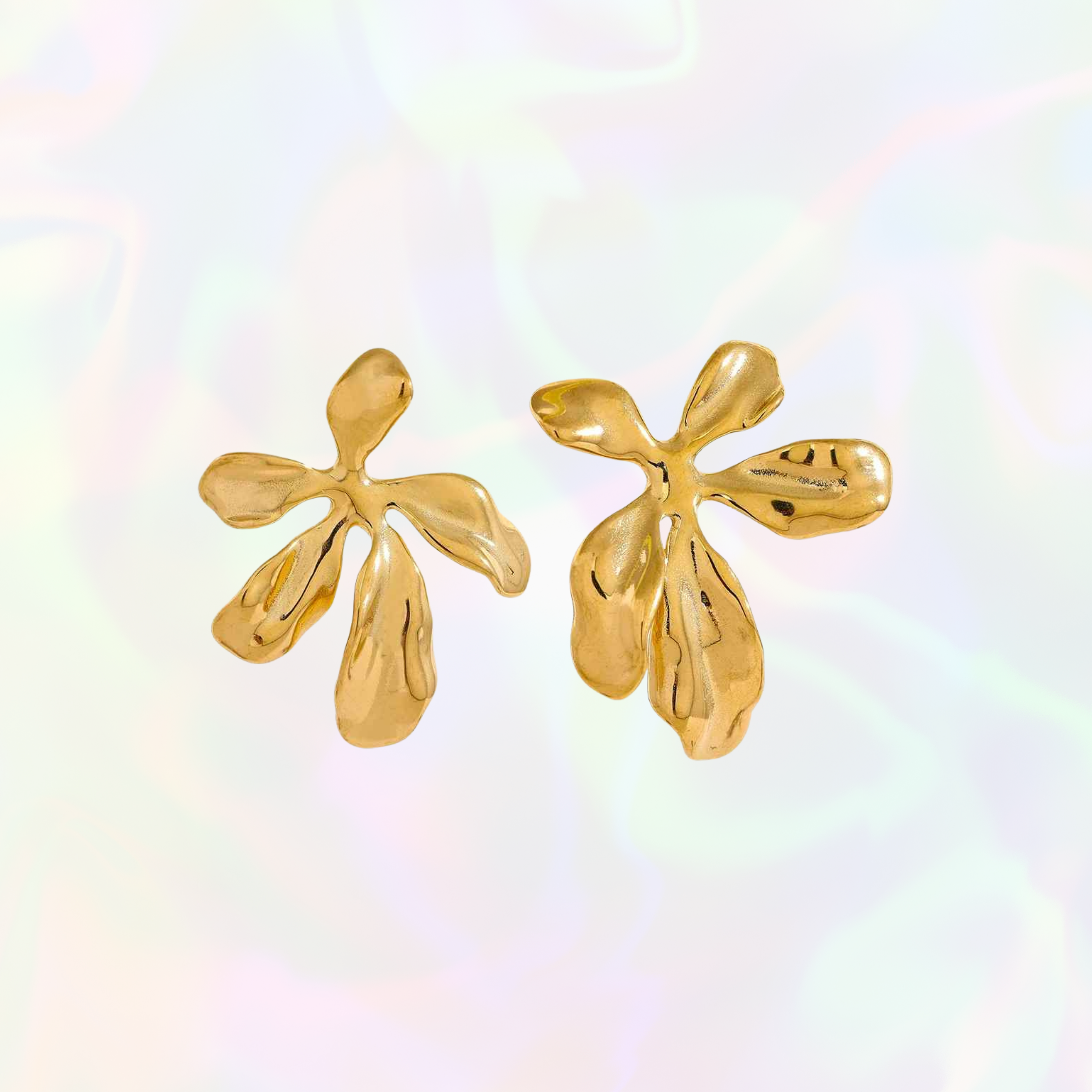 Big gold feminine floral earrings on a multicolored background