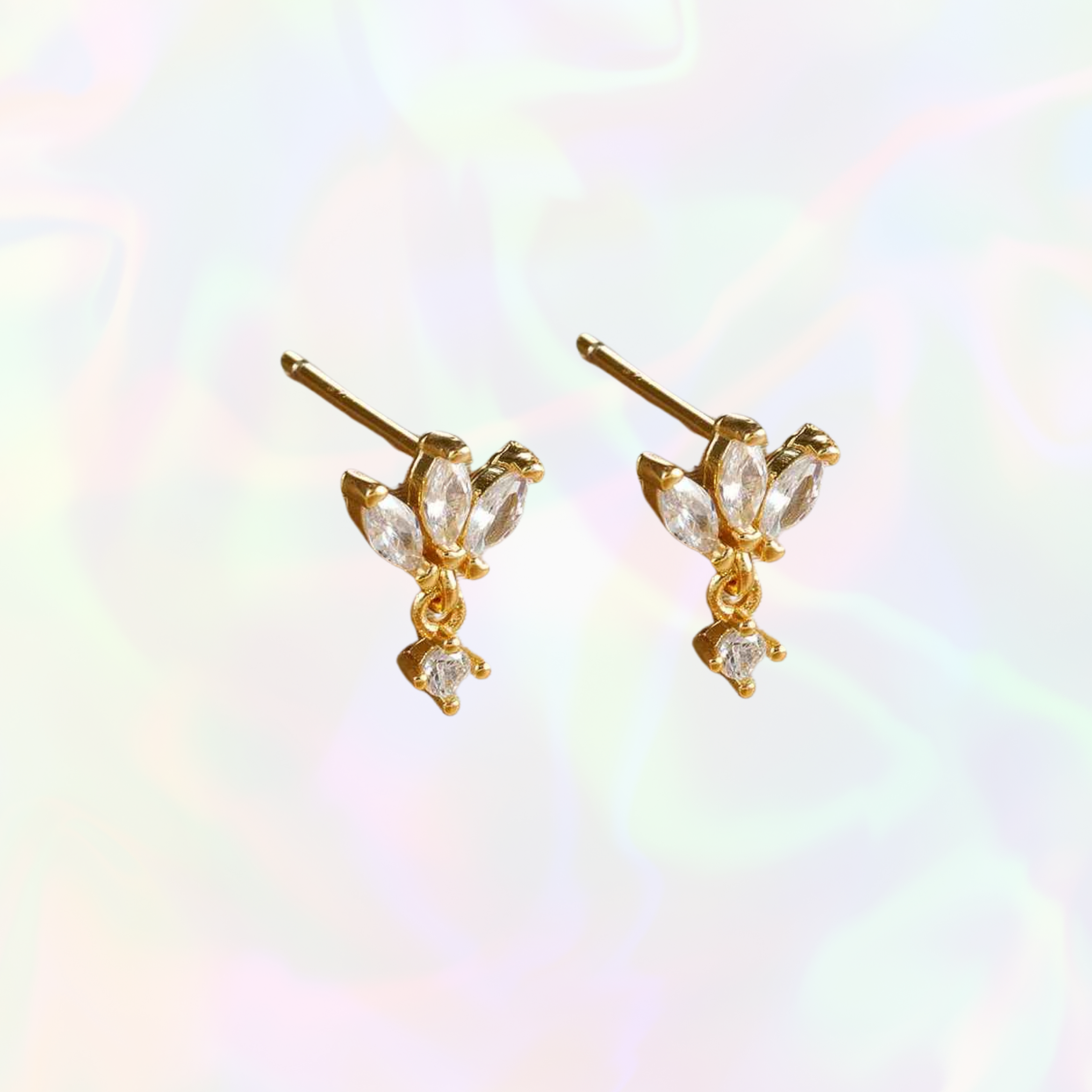 Gold dangly stud earrings with clear gemstones on a multicolored background