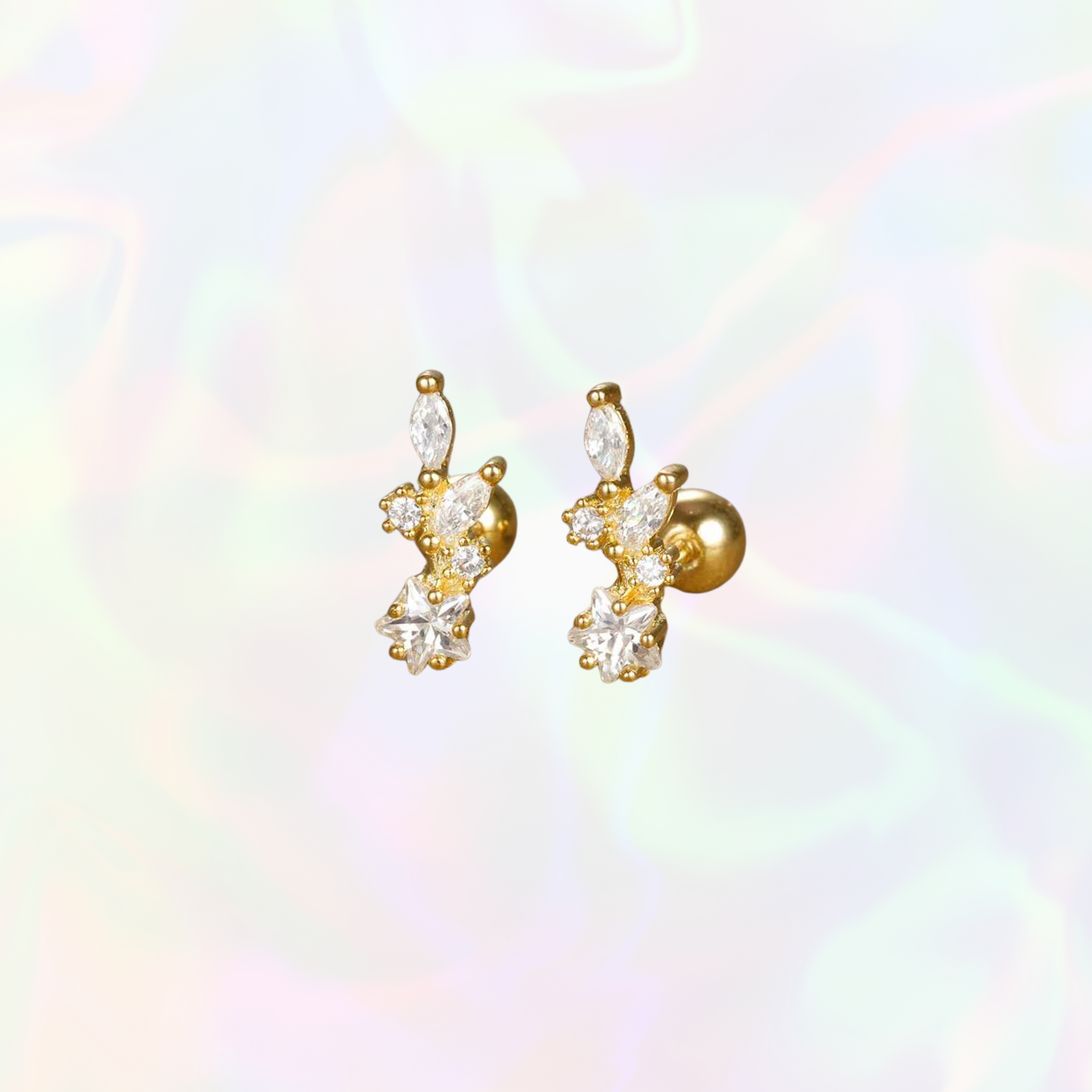 Gold and crystal earrings on a soft, multicolored background