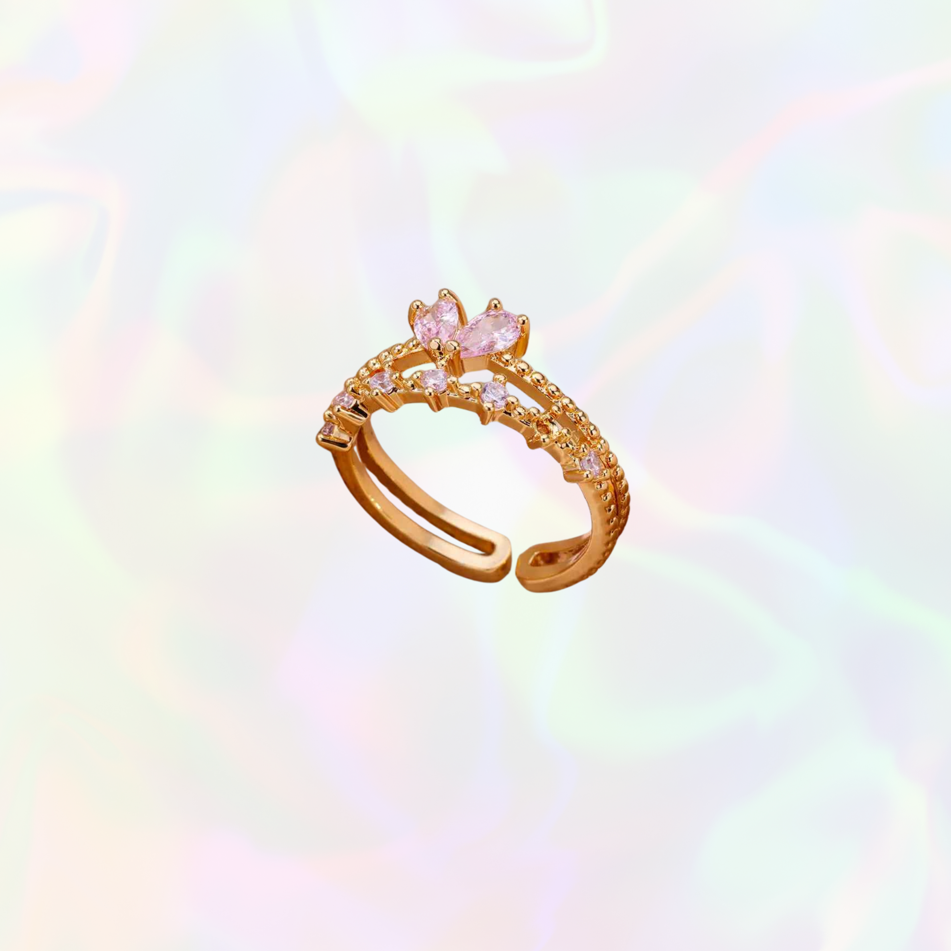 Feminine adjustable gold ring with pink gemstone on a colorful gradient background