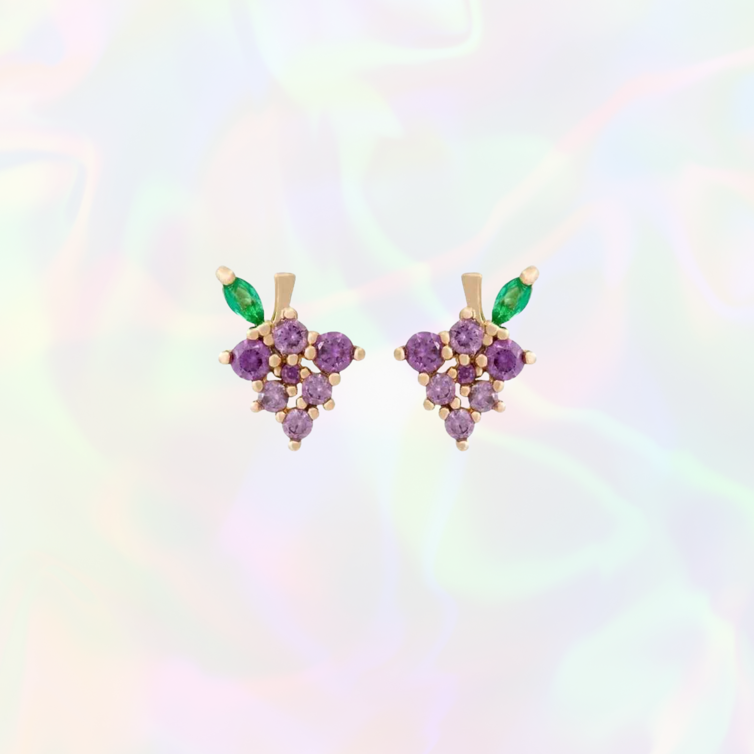 Pair of grape earrings with purple and green gemstones on a colorful gradient background