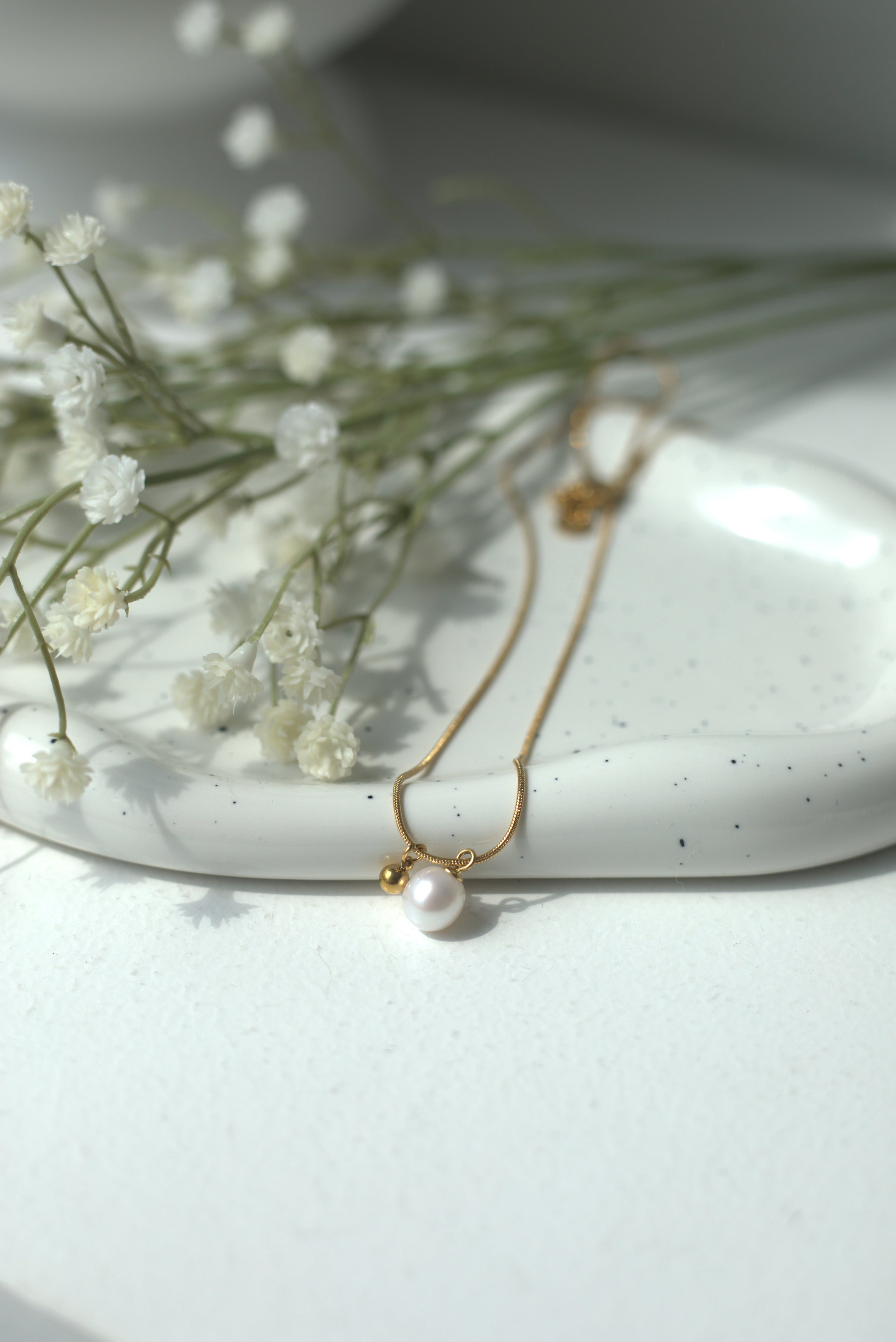 gold necklace with pearl accent