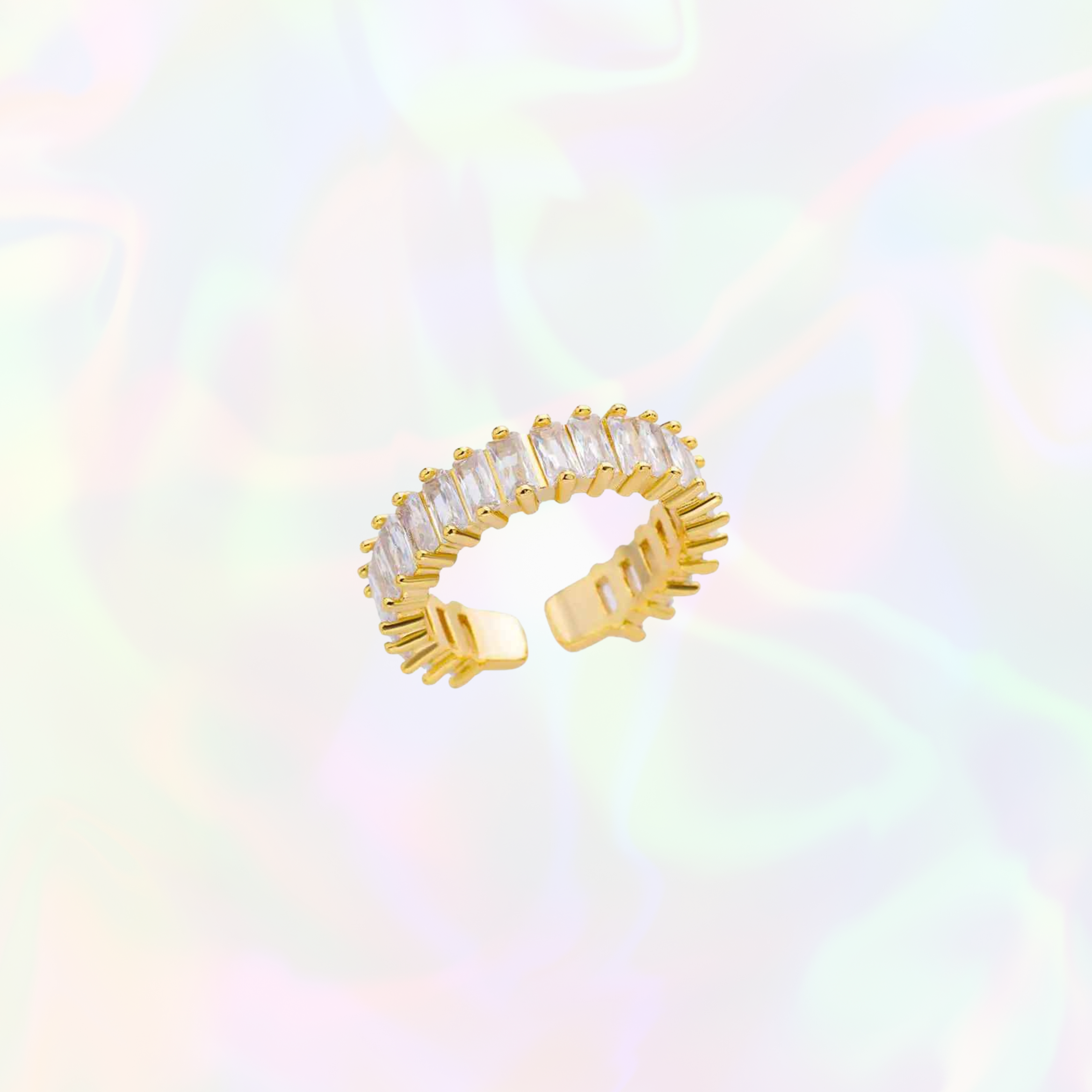 Gold bulky ring with clear gemstones on a multicolored background. Adjustable in size