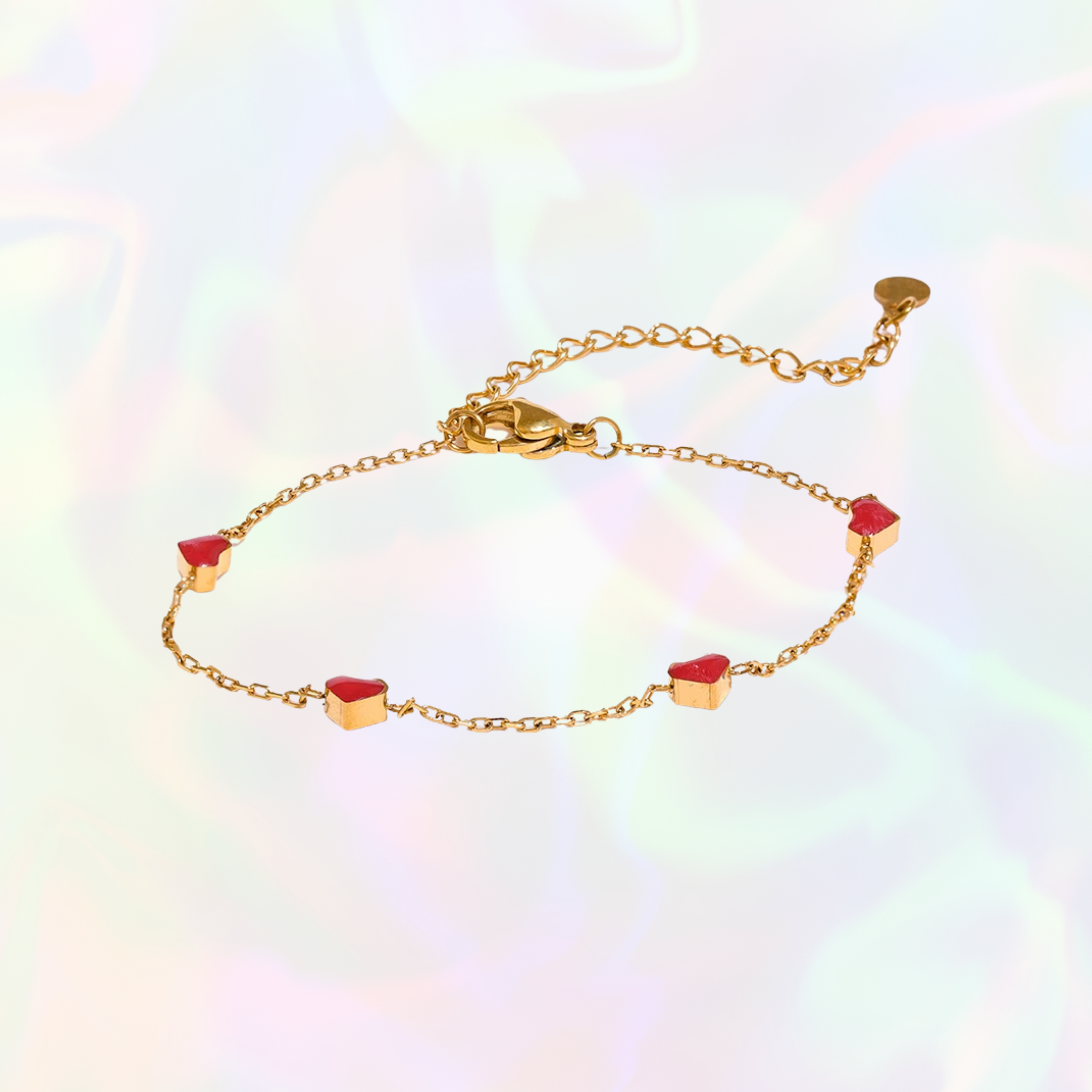 Gold bracelet with red heart charms on a rainbow gradient background