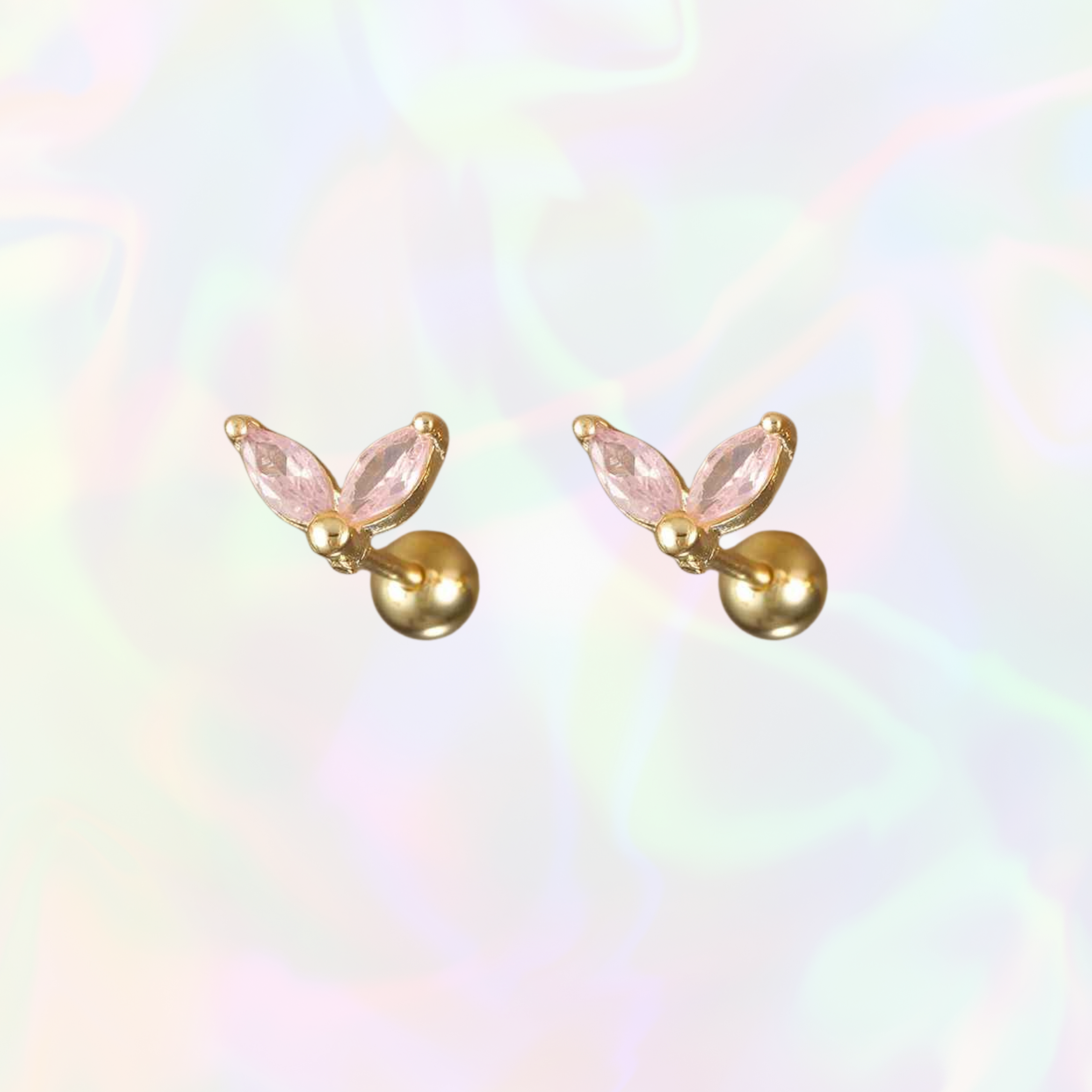 Gold stud earrings with pink whale tale gemstones on a multicolored background