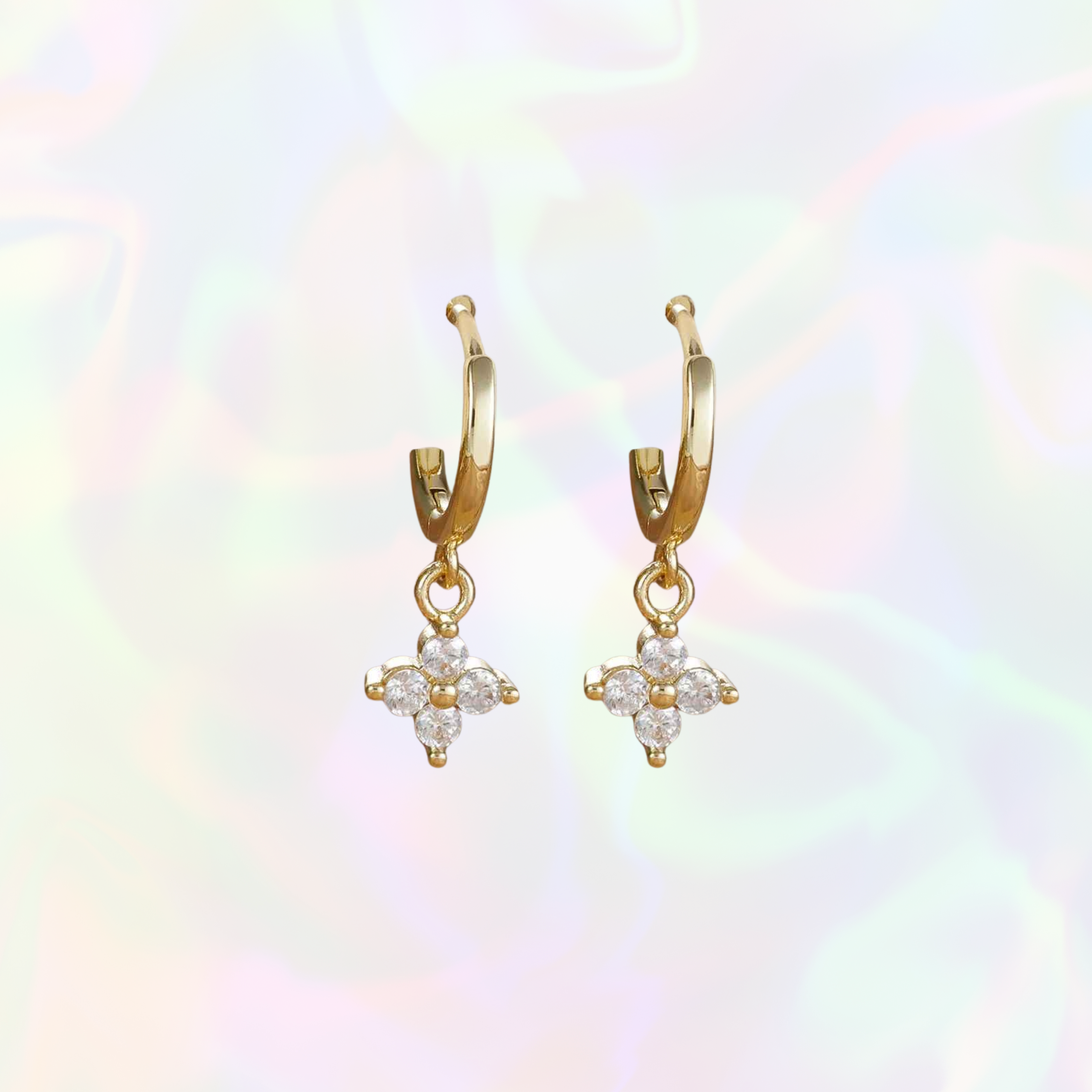 Gold star hoop earrings with floral designs on a multicolored background