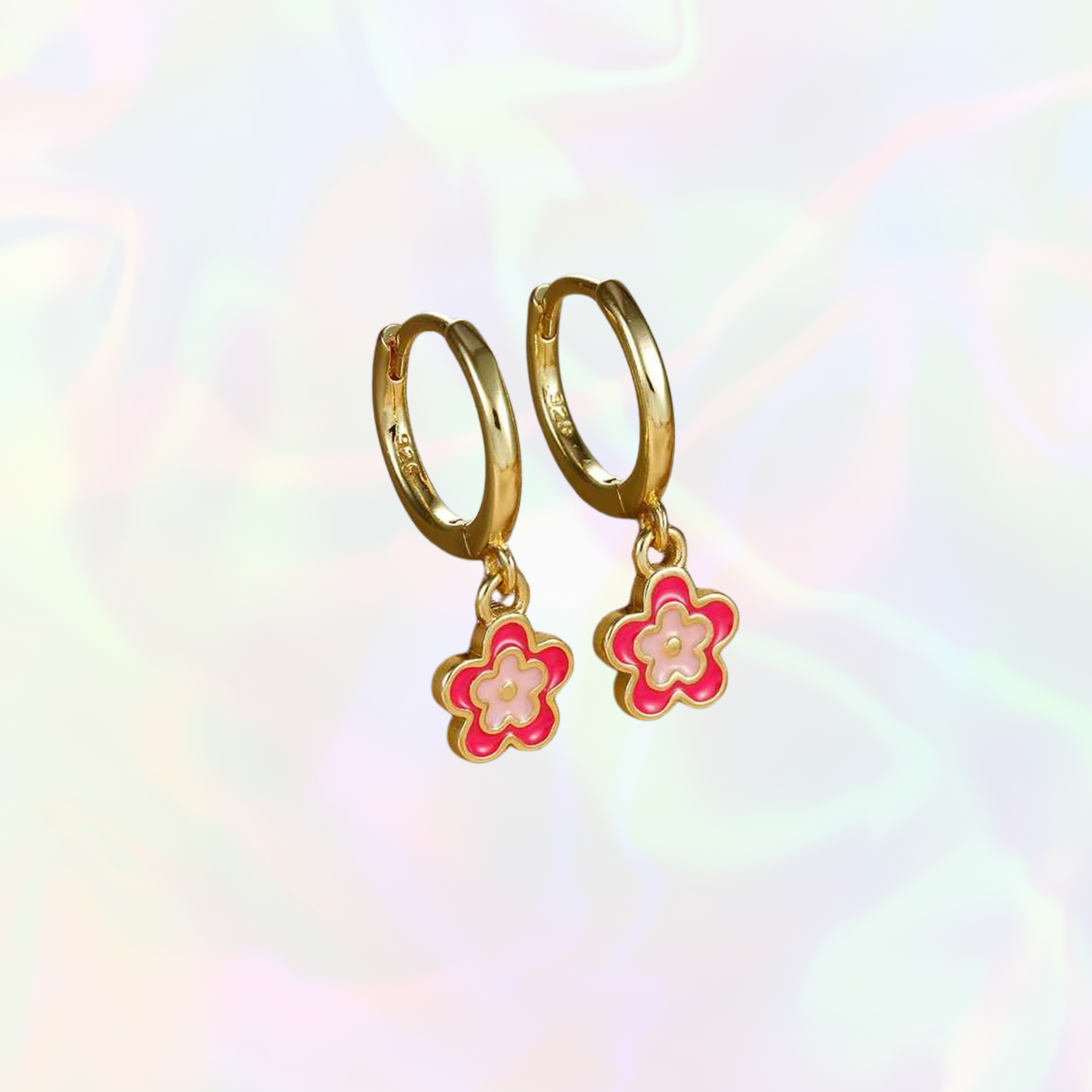 Gold hoop earrings with pink and red flower charms on a rainbow gradient background