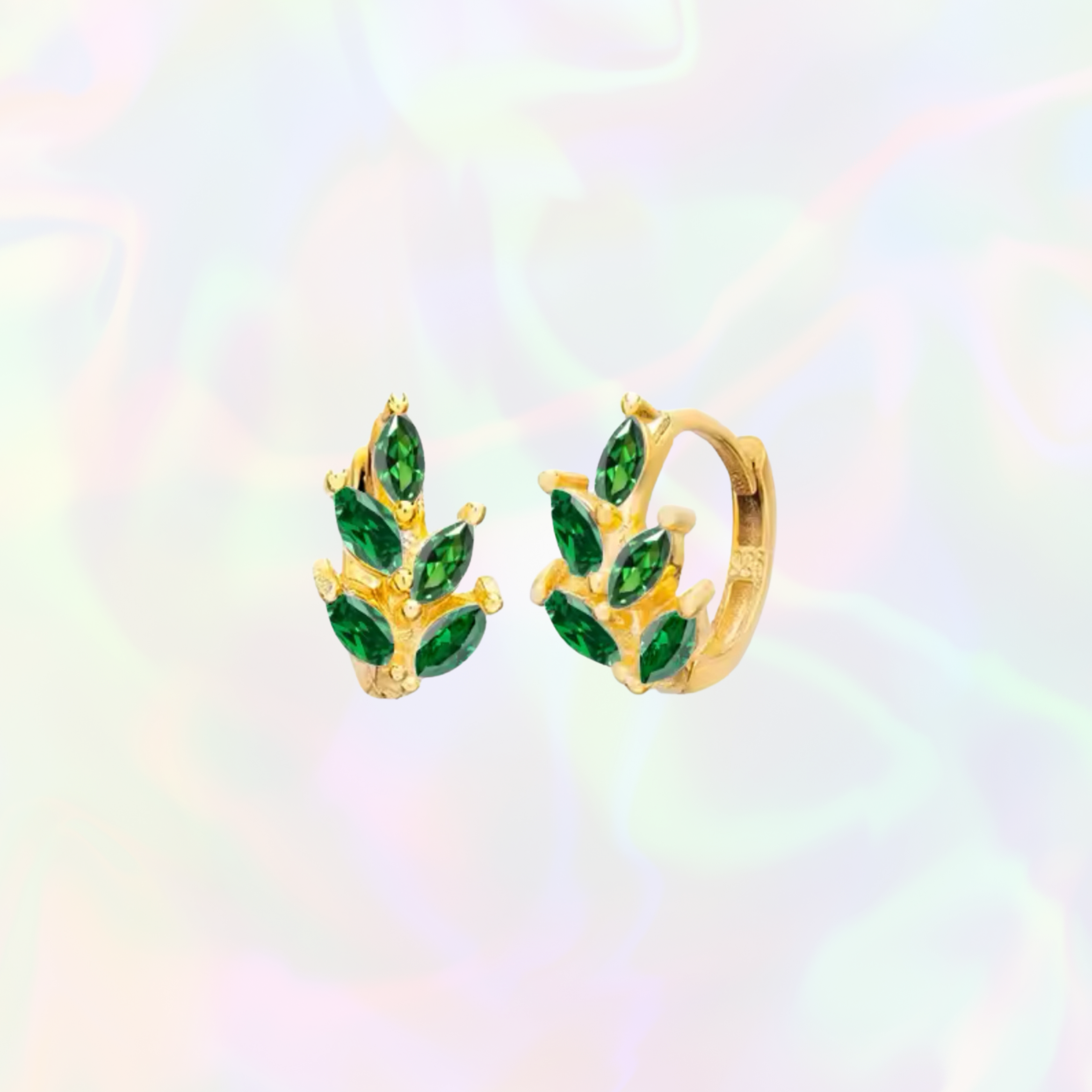 Gold hoop earrings with green gemstones on a multicolored background