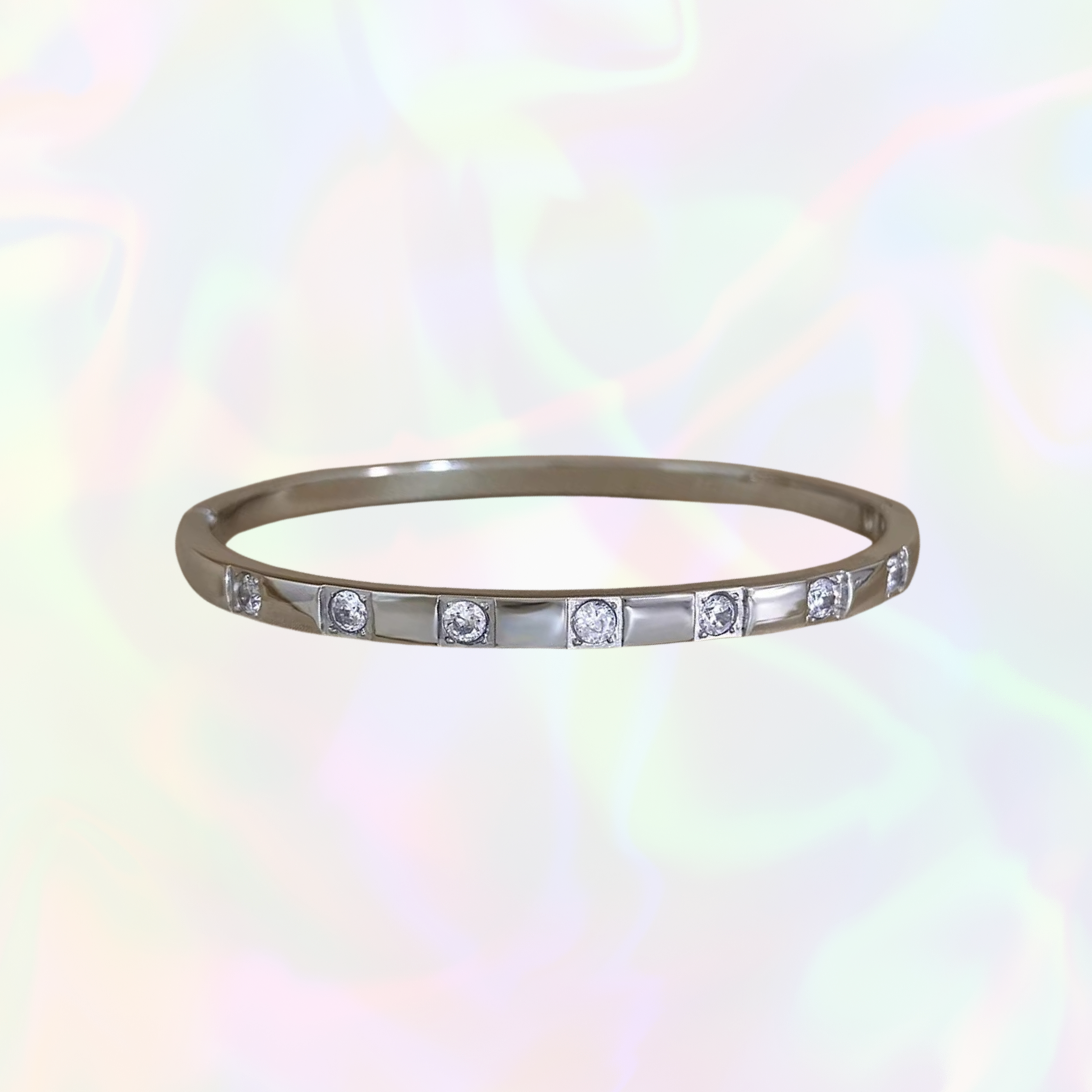 Silver bracelet with small gemstones on a white background