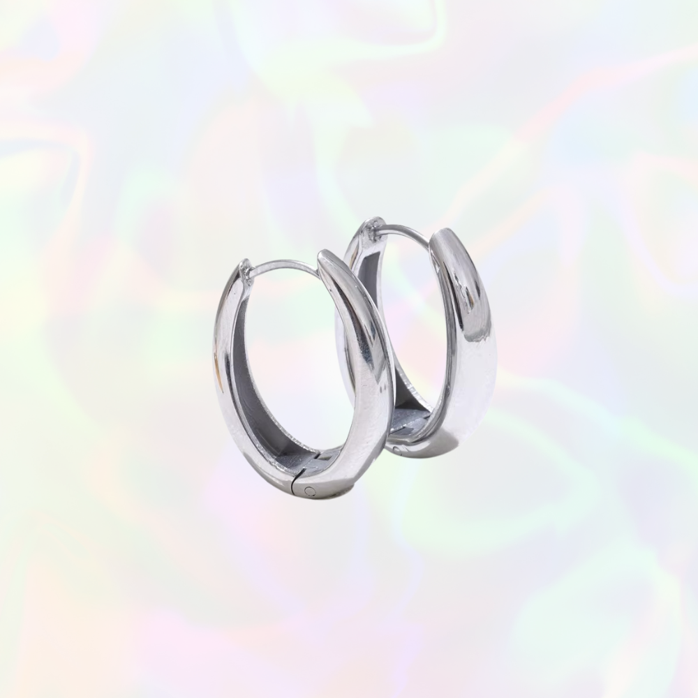 Silver hoop earrings on a multicolored gradient background